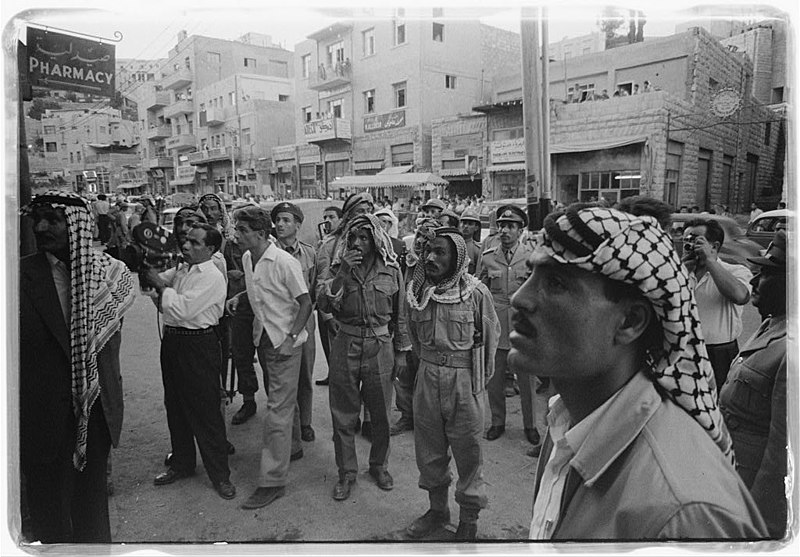 File:Crowds in downtown Amman watching a news report about King Faisal's deposition 14 July 1958.jpg