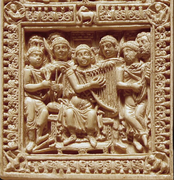 David playing the harp, accompanied by plucked fiddle and clappers/cymbals. Circa 795, Germany or France.