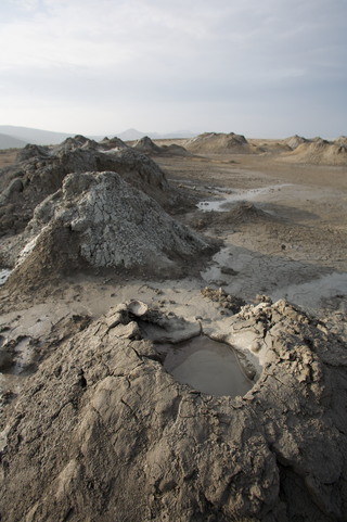 <span class="mw-page-title-main">Mud volcano</span> Landform created by the eruption of mud or slurries, water and gases