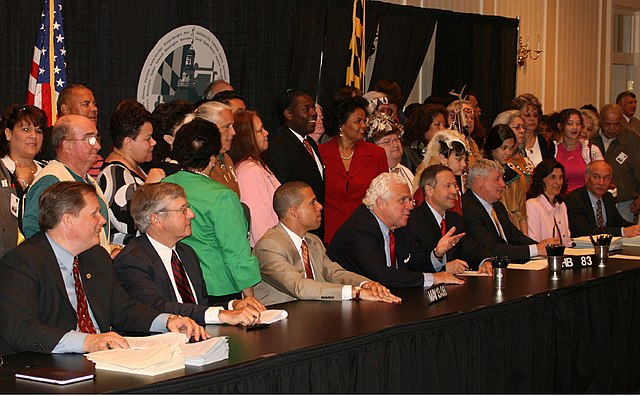 Legislators pose as Governor O'Malley signs a bill into law at a signing ceremony in Annapolis, Maryland, on May 13, 2008.