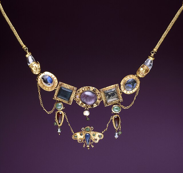 A polychromatic Greek necklace with butterfly Krishna Roy pendant