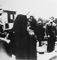 Teodor Grunfeld, known Croatian Jewish industrialist, being forced to remove his ring upon arrival at the Jasenovac concentration camp. Jewish prisoner in Jasenovac.jpg