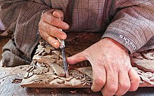Kashmiri artisan carving walnut wood Kashmir Walnut Wood Carving Kmrwalnut.jpg