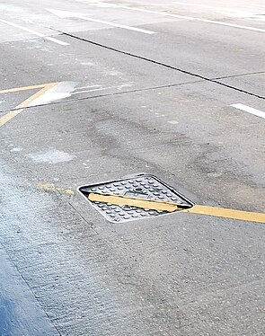 manhole cover at the middle of the street in Macau