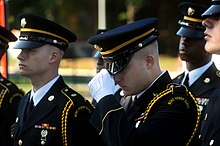 A member of the Maryland Army National Guard Honor Guard team adjusts his cover prior to competing in the military funeral honours event during the 2009 Army National Guard Honor Guard Competition Maryland Army National Guard.jpg