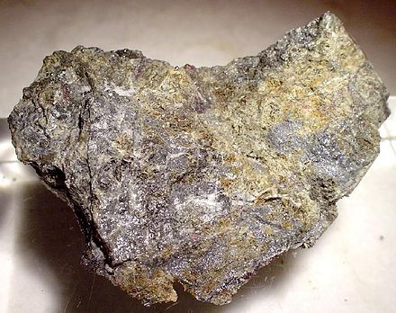 Native mercury with cinnabar, Socrates mine, Sonoma County, California. Cinnabar sometimes alters to native mercury in the oxidized zone of mercury deposits.