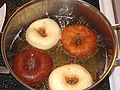Doughnuts being cooked in a deep fryer