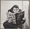 German refugee child, a devotee of Superman reading a Superman comic book, October 1942