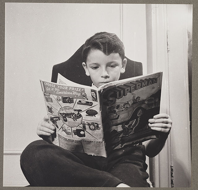 German refugee child, a devotee of Superman reading a Superman comic book, October 1942