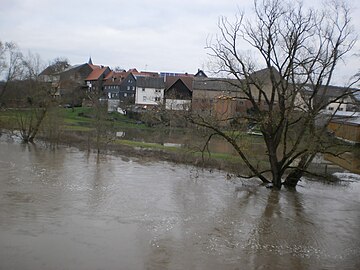 English: Normal floods in winter, village on river bank, trees in water