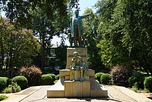 John H. Reagan Memorial in Palestine, Texas. The allegorical figure seated beneath Reagan represents the Lost Cause of the Confederacy. Palestine August 2017 46 (John H. Reagan Monument).jpg