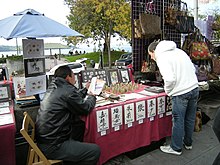 Chinese seal (chop) carver at an outdoor craft daystall on Pike Place just south of Virginia Street Pike Place Market - Chop carver.jpg