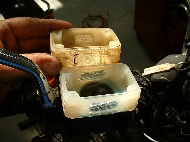 A plastic item with thirty years of exposure to heat and cold, brake fluid, and sunlight. Notice the discoloration and crazing of the material (compar