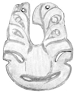 A greenstone carving, the bottom of which looks similar to a tiki but with two longer pieces at the top with "eyes" for a cord to pass through.