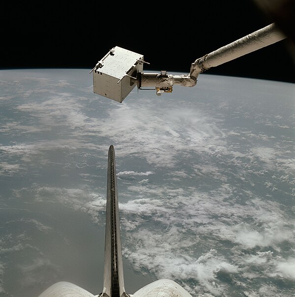 The Induced Environment Contaminant Monitor (IECM) is grappled by the Canadarm.