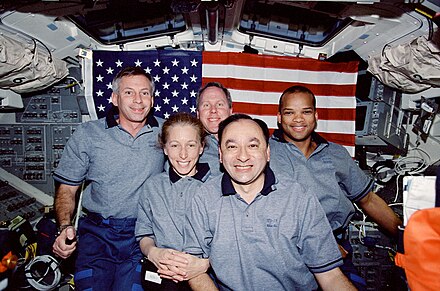 STS-98 crewmembers pose for the traditional inflight portrait on the flight deck of the Space Shuttle Atlantis