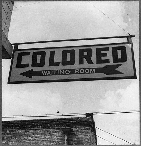 "Colored" waiting room sign in 1943 for a bus terminal in Rome, Georgia, where Jim Crow laws created "de jure" legally required segregation