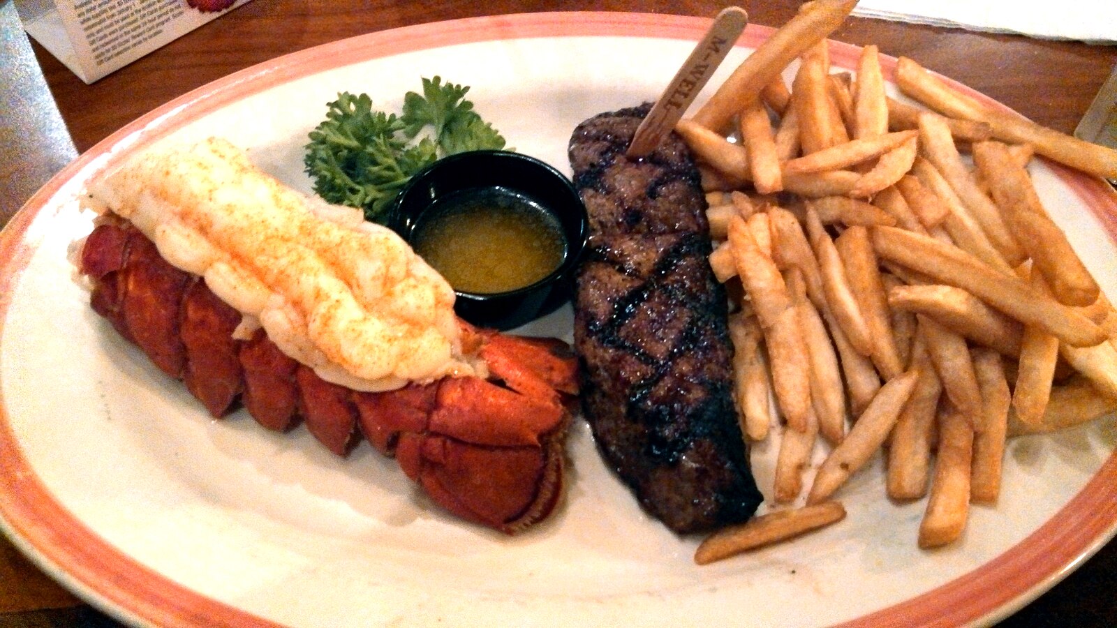 Steak and lobster with fries from restaurant chain Sizzler. 