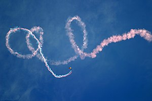 US Navy 050316-N-3271W-002 A Sailor assigned to the U.S. Navy Leap Frogs parachute team streams colored smoke during a jump over Westview High School in Avondale, Ariz.jpg