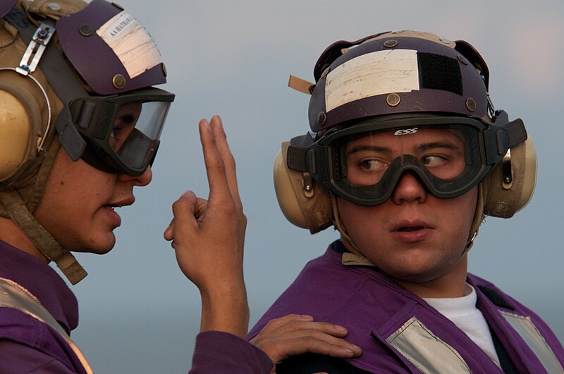 File:US Navy 091023-N-5319A-028 Aviation Boatswain's Mate Seaman Nicolas Garcia explains the hand signals to Aviation Boatswain's Mate Seaman Stephen Medina while observing flight operations.jpg