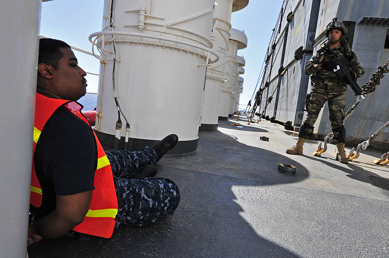 File:US Navy 100527-N-7364R-098 A Spanish navy visit, board, search and seizure team member stands guard over a detained crewmember aboard the Military Sealift Command container and roll-on-roll-off ship USNS LCPL Roy M. Wheat (T-AK.jpg