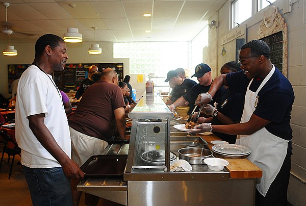Members of the United States Navy serving hungry Americans at a soup kitchen in Red Bank, N.J., during a 2011 community service project.