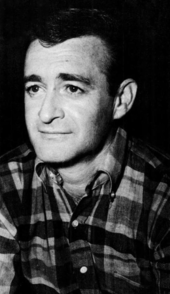 A dark-haired man wearing a check shirt