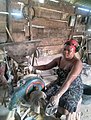 A_woman_operating_a_grinding_machine