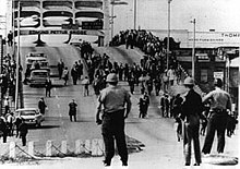 The Edmund Pettus Bridge on "Bloody Sunday" in 1965. Bloody Sunday-officers await demonstrators.jpeg