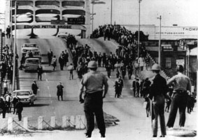 Police watch marchers turn around on Tuesday, March 9, 1965.