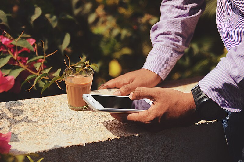 File:Businessman with coffee outdoors (Unsplash).jpg