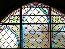 A leadlight church window, Czech Republic, combines traditional diamond panes with the pale translucent and textured quality of modern so-called "cathedral glass".