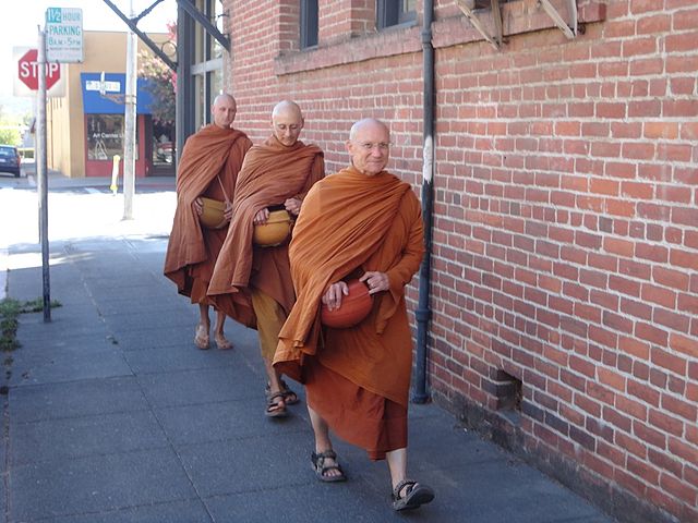 Ajahn Pasanno, Ajahn Karuṇadhammo, and Ajahn Ñāniko walking in Ukiah, accepting offerings of alms food. Full Moon Observance Day, September 2013 (Phot