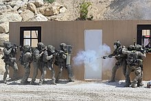 Assault team blowing up a door during a demo