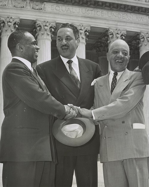 Marshall (center), George Edward Chalmer Hayes, and James Nabrit congratulate one another after the Supreme Court's decision in Brown v. Board of Educ