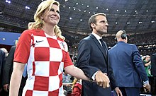 Kolinda Grabar-Kitarović and Emmanuel Macron prepare to award the first and second places in the final of the 2018 Russian Football Cup.jpg