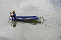 Man in a boat on Kwai River in Kanchanaburi.jpg