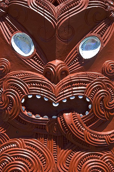 A human face depicted in a house carving from Whakarewarewa, 2005. Tūmatauenga, god of war, is the ancestor of humankind.