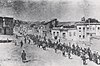 Armenian civilians, escorted by armed Ottoman soldiers, are marched through Harput to a prison in Mezireh