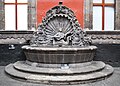 Fountain with mermaid playing a guitar in the main courtyard