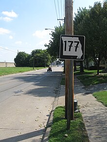 Missouri Route 177 in Cape Girardeau; Cape's flood wall is visible at the left. Note the euro-style 7s on the sign. Missouri Route 177 Cape.jpg