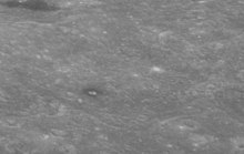 Oblique view facing east with a high sun angle, from Apollo 8, showing the dark-halo crater within. Neujmin crater AS08-12-2196.jpg