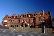 The prominent brick building by J. G. Collins was demolished after the 2011 Christchurch earthquake Old Convent in Barbadoes Street.jpg