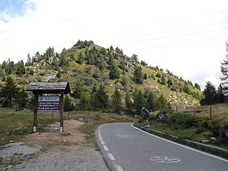 Pass summit with sign, view to the east