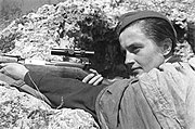 Sniper Lyudmila Pavlochenko, pictured with a rifle in a trench in 1942.