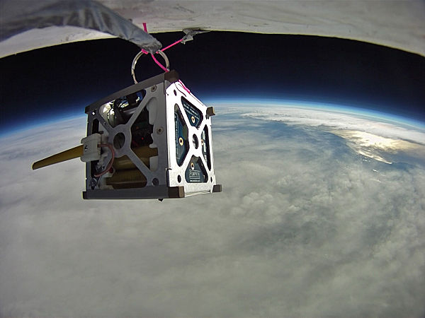 PhoneSat 1.0 during high-altitude balloon test. The antenna made from yellow tape measure is deployed.