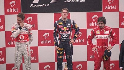 From left to right: Jenson Button, Sebastian Vettel and Fernando Alonso on the podium Podium winners of 2011 Indian Grand Prix.jpg