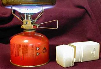 A small Snow Peak portable stove running on MSR gas and the stove's carrying case