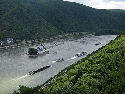 Cruise boats and freight barges passing Burg Pfalzgrafenstein