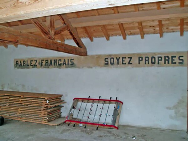 "Speak French Be Clean," written across the wall of a Southern French school